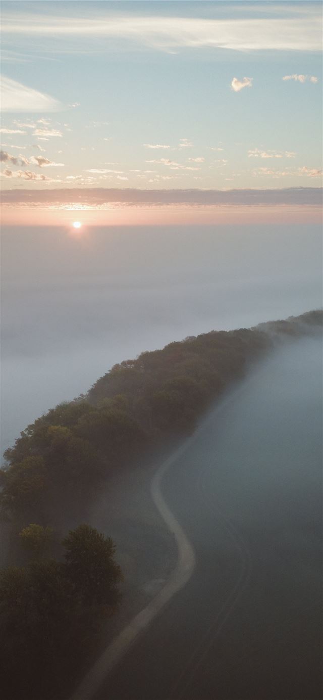 1125x2436 aerial photography of road beside trees covered wi... - sunset iPhone 11 Wallpaper