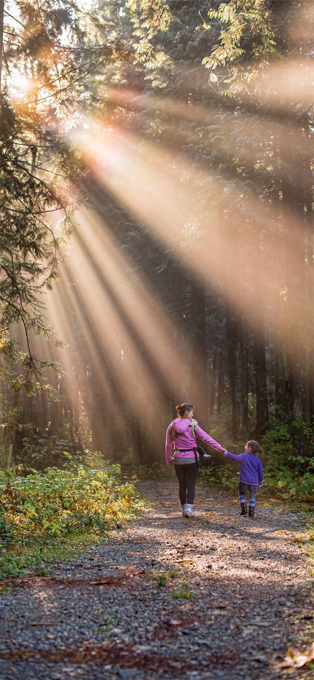 1125x2436 woman walking in forest with child - cute iPhone 11 Wallpaper
