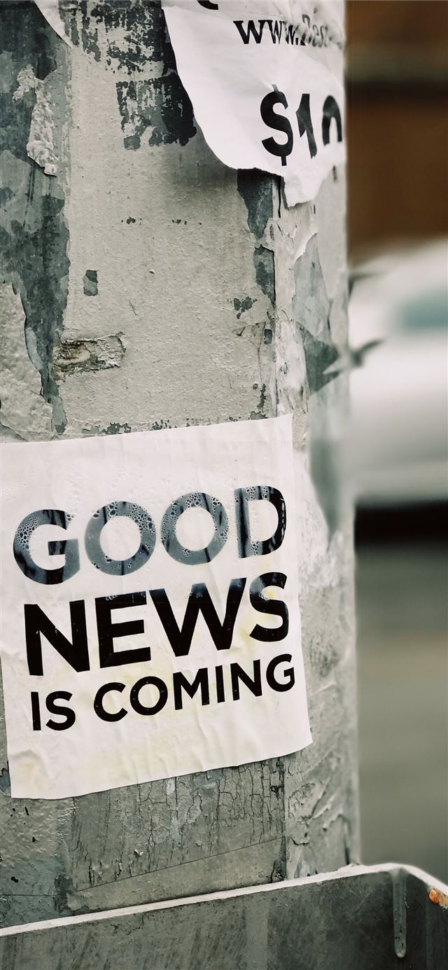 1125x2436 white Good News Is Coming paper on wall -  iPhone 11 Wallpaper
