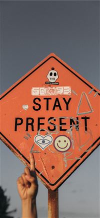 person pointing Stay Present road sign during dayt... wallpaper