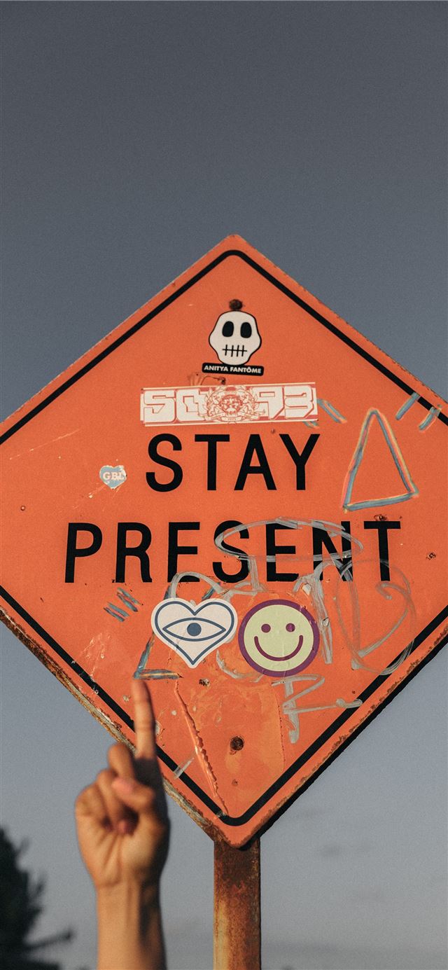 1125x2436 person pointing Stay Present road sign during dayt... - quotes iPhone 11 Wallpaper