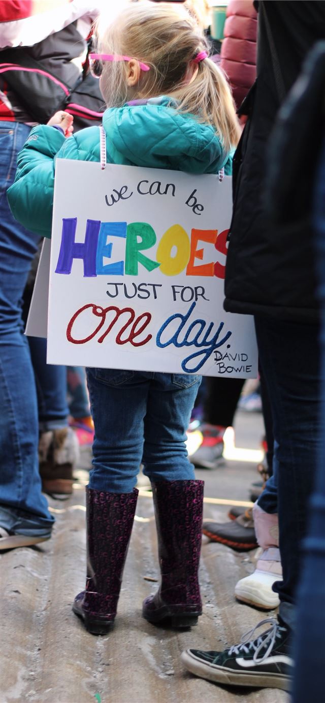 1125x2436 girl carrying white signage board -  iPhone 11 Wallpaper