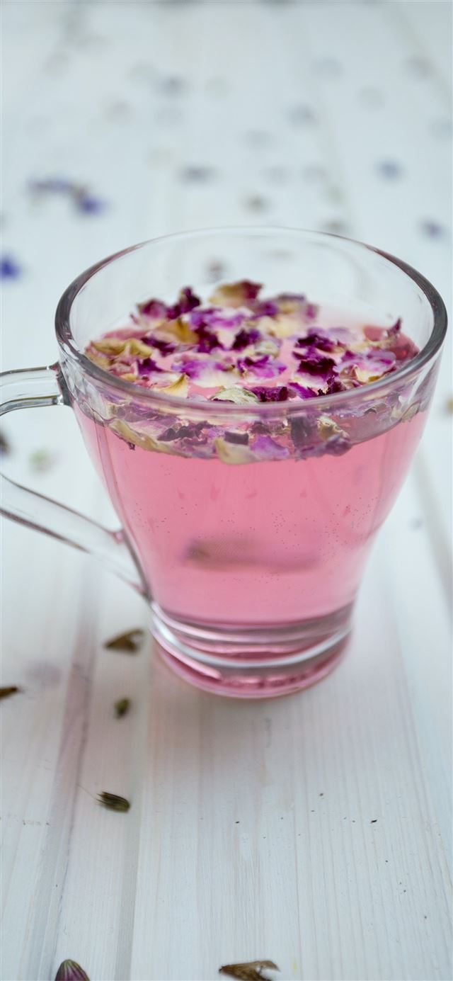 1125x2436 clear glass cup surrounded by petals - spring iPhone 11 Wallpaper