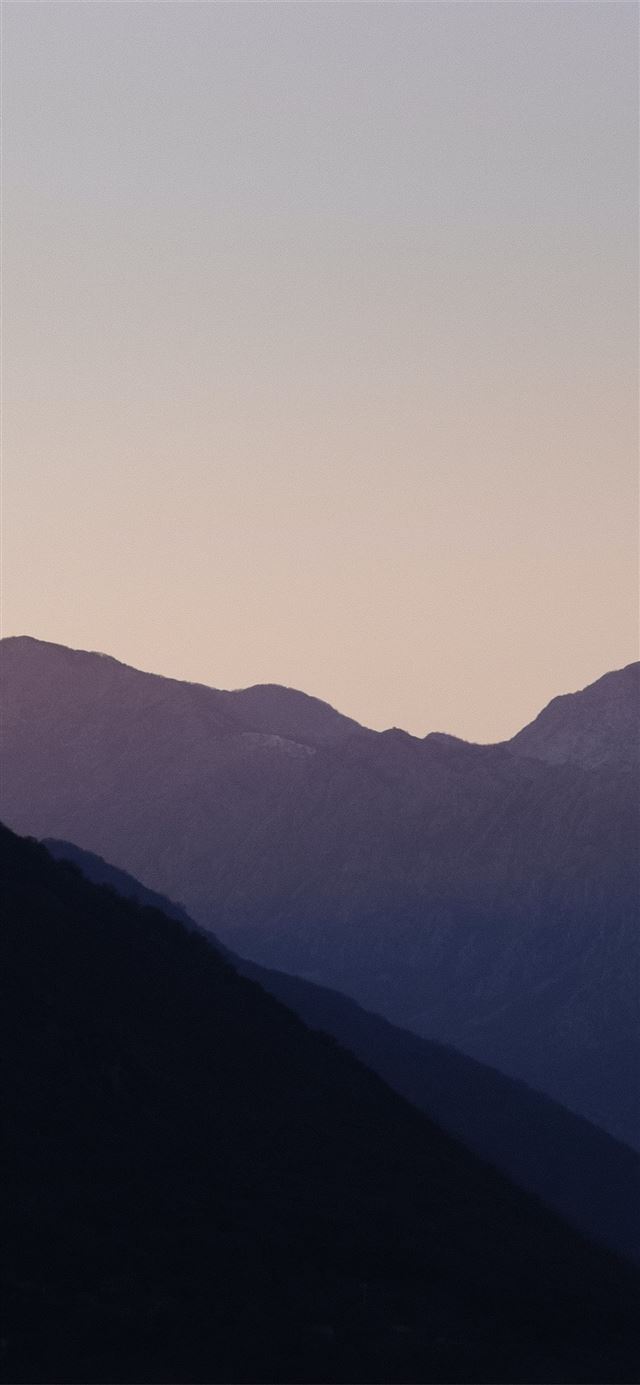 1125x2436 silhouette of mountains during daytime - mountain iPhone 11 Wallpaper