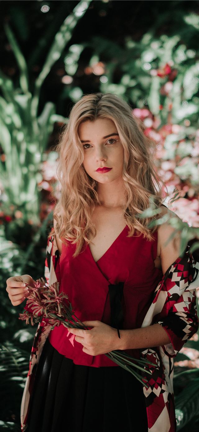1125x2436 woman holding flowers in front of the garden - sydney iPhone 11 Wallpaper