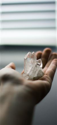 person holding crystal stones iPhone 11 wallpaper