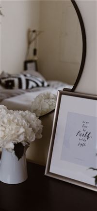 white potted flowers beside photo frame iPhone 11 wallpaper