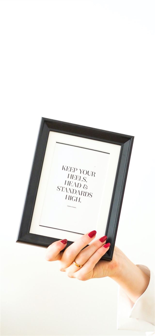 1125x2436 person holding black framed white arabic text - quotes iPhone 11 Wallpaper