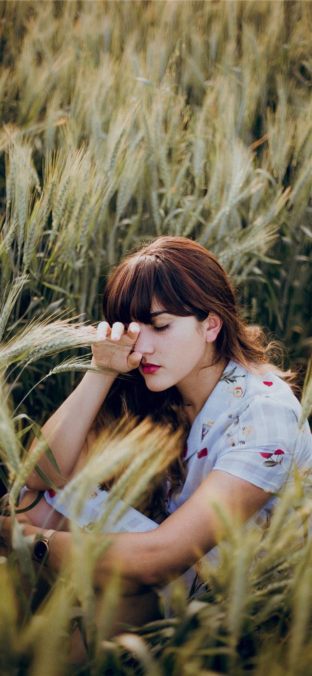 1125x2436 woman sitting on grass - mexico iPhone 11 Wallpaper
