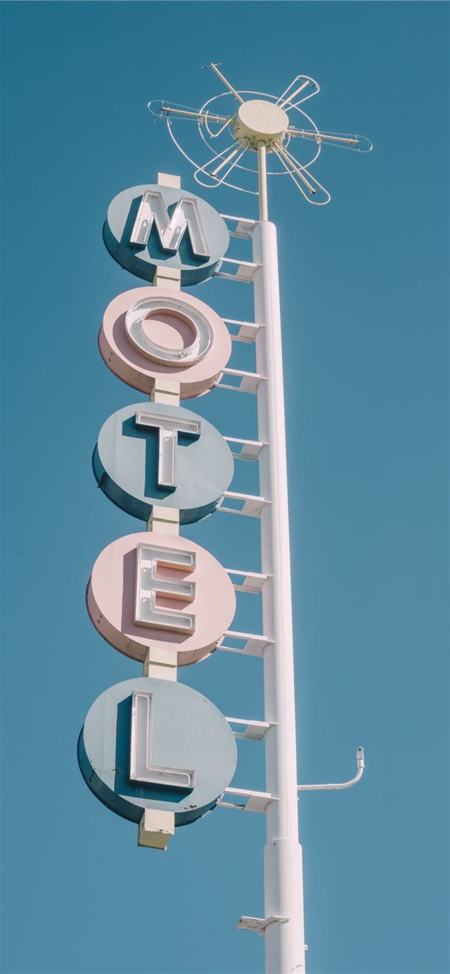 1125x2436 white and teal metal motel signage - albuquerque iPhone 11 Wallpaper