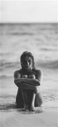 grayscale photo of woman on seashore wallpaper