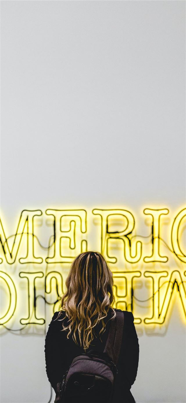 1125x2436 woman in front American lighted signage - the broad iPhone 11 Wallpaper