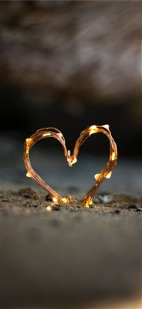 close up photography of heart shaped fairy lite on... iPhone 11 wallpaper