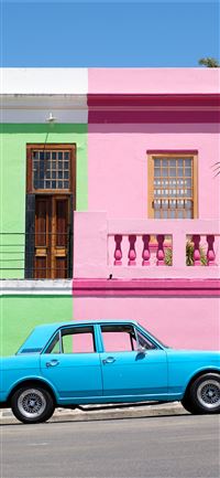 blue sedan parked beside pink and green house iPhone 11 wallpaper