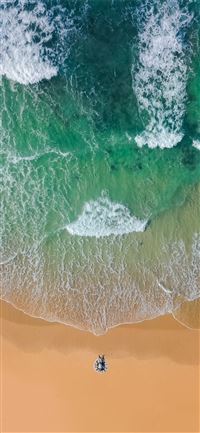 top view photography of brown sand on beach with t... iPhone 11 wallpaper