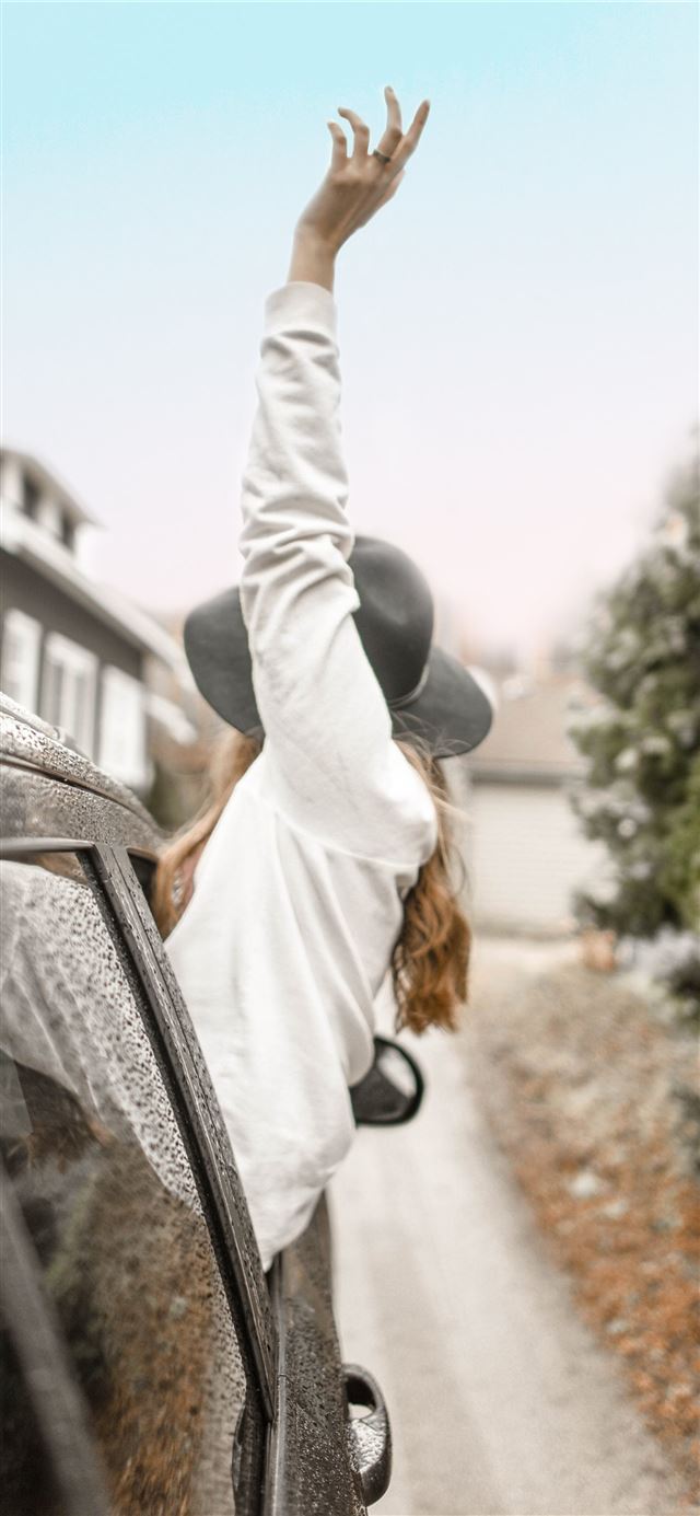1125x2436 woman rising left hand on vehicle window during da... -  iPhone 11 Wallpaper
