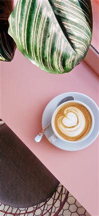 cup of coffee on saucer with teaspoon on pink tabl... iPhone 11 wallpaper