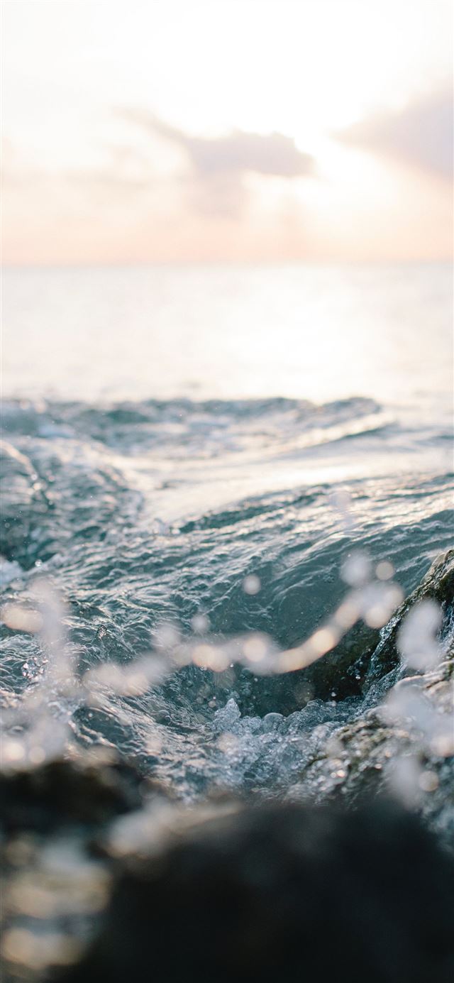 1125x2436 ocean wave at the rocky shore - water iPhone 11 Wallpaper