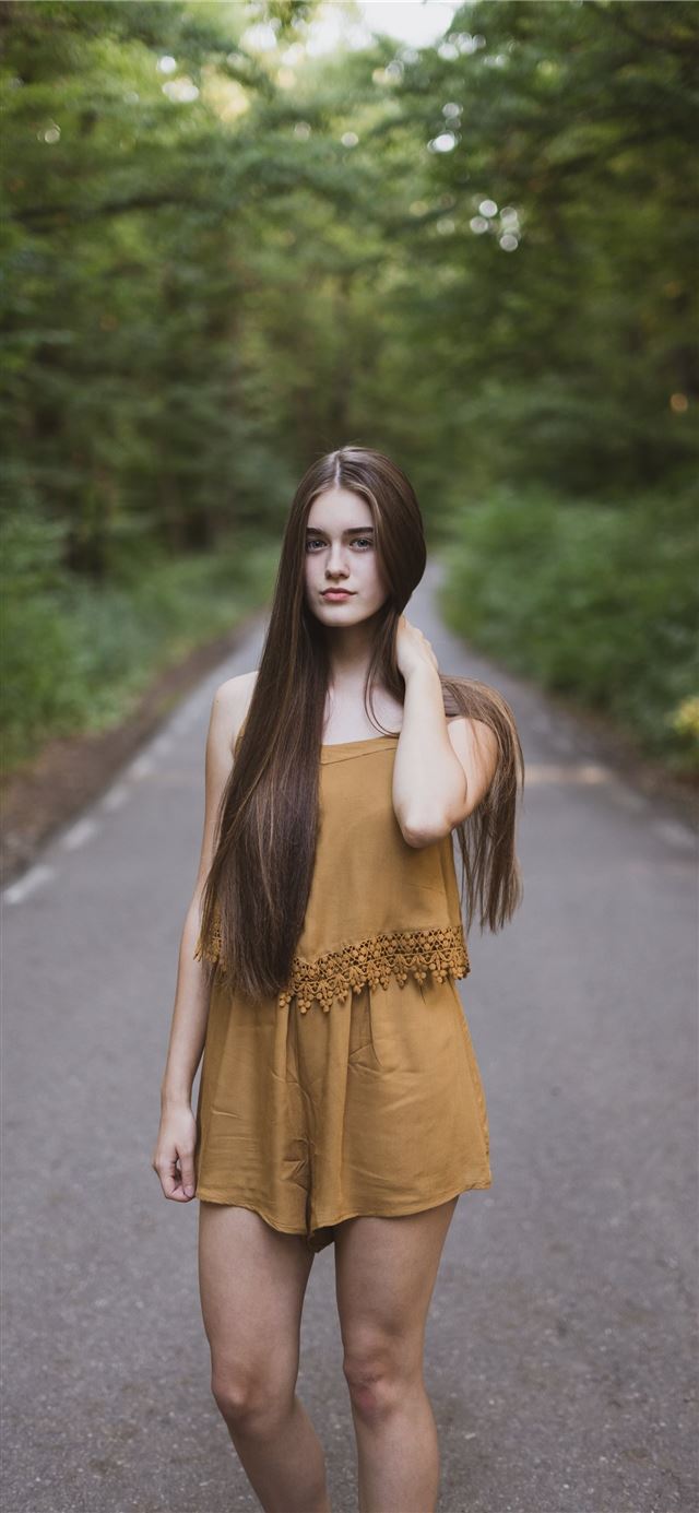 1125x2436 woman standing at highway - romania iPhone 11 Wallpaper