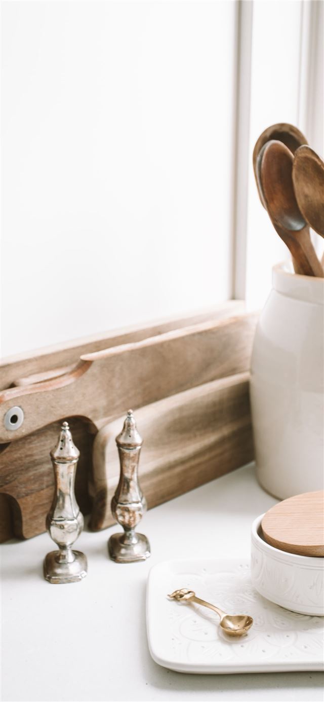 1125x2436 brown wooden spoons on ceramic canister on white t... - white iPhone 11 Wallpaper