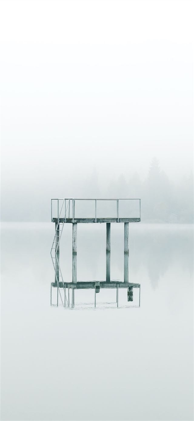 1125x2436 photography gray metal tower near body of water du... - water iPhone 11 Wallpaper