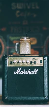 black Marshall guitar amplifier with glass mug on ... wallpaper