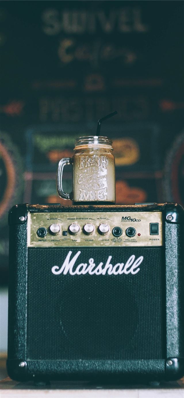 1125x2436 black Marshall guitar amplifier with glass mug on ... - coffee iPhone 11 Wallpaper
