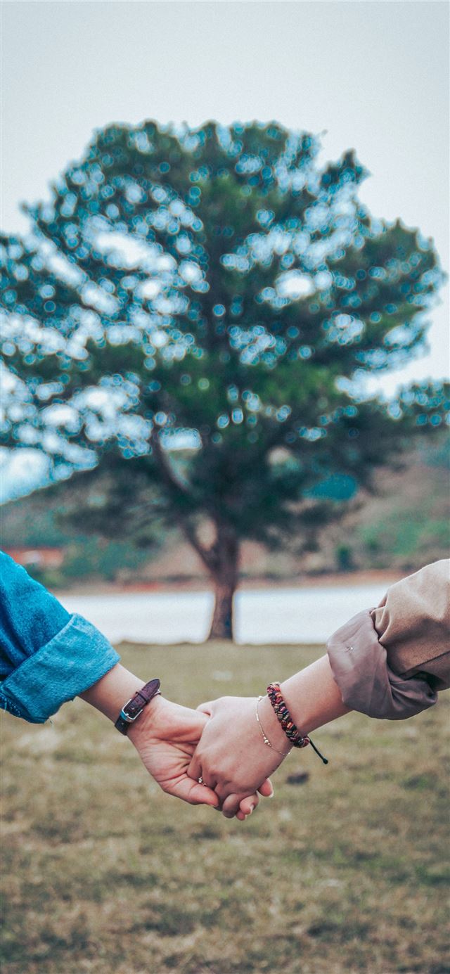 1125x2436 two persons holding hands - love iPhone 11 Wallpaper