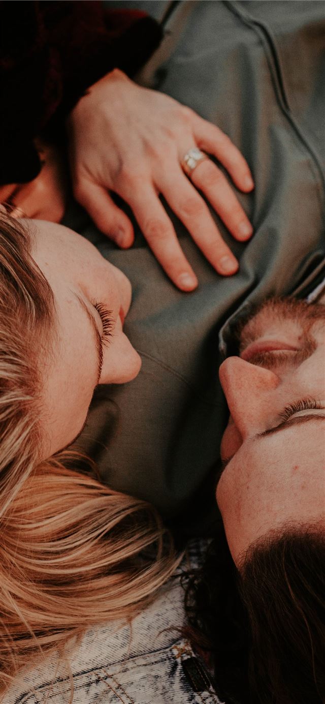 1125x2436 a woman stares into a man's eyes lovingly - love iPhone 11 Wallpaper