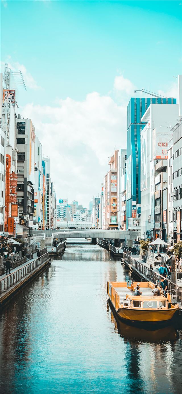 1125x2436 river in between street and high rise buildings - japan iPhone 11 Wallpaper