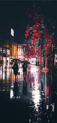 people walking holding umbrella at night wallpaper