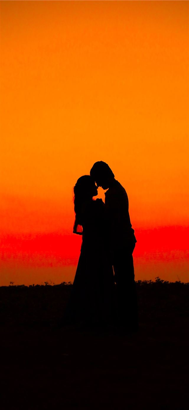 1125x2436 silhouette of man and woman during sunset - love iPhone 11 Wallpaper