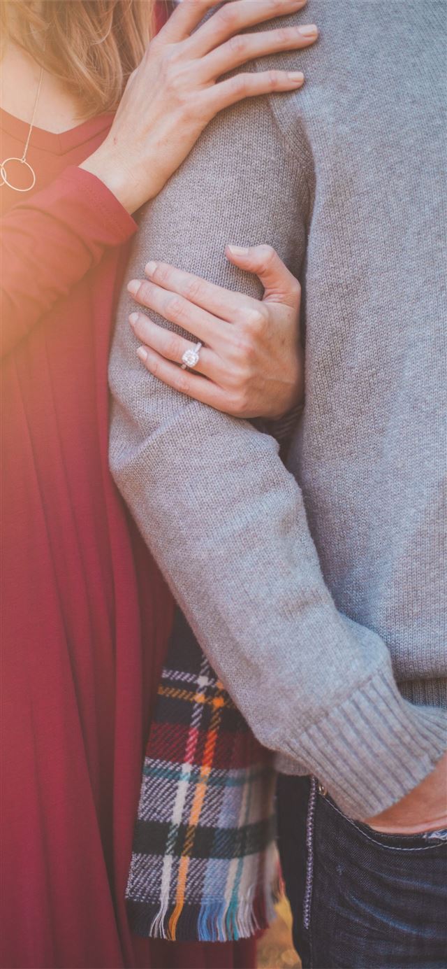 1125x2436 woman holding the shoulder of man - love iPhone 11 Wallpaper