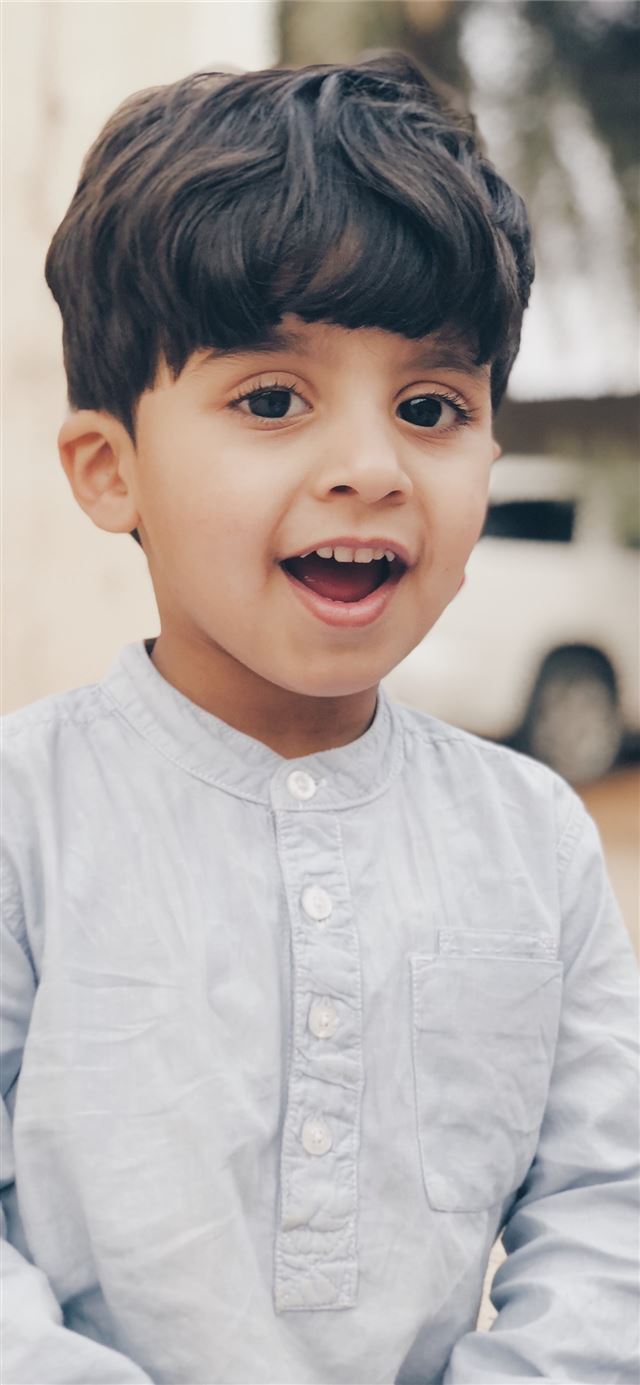 1284x2778 boy in white dress shirt smiling -  iPhone 11 Wallpaper