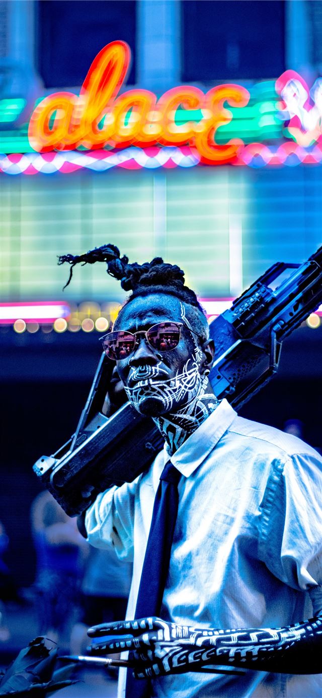 1125x2436 man with tattoo carrying rifle -  iPhone 11 Wallpaper