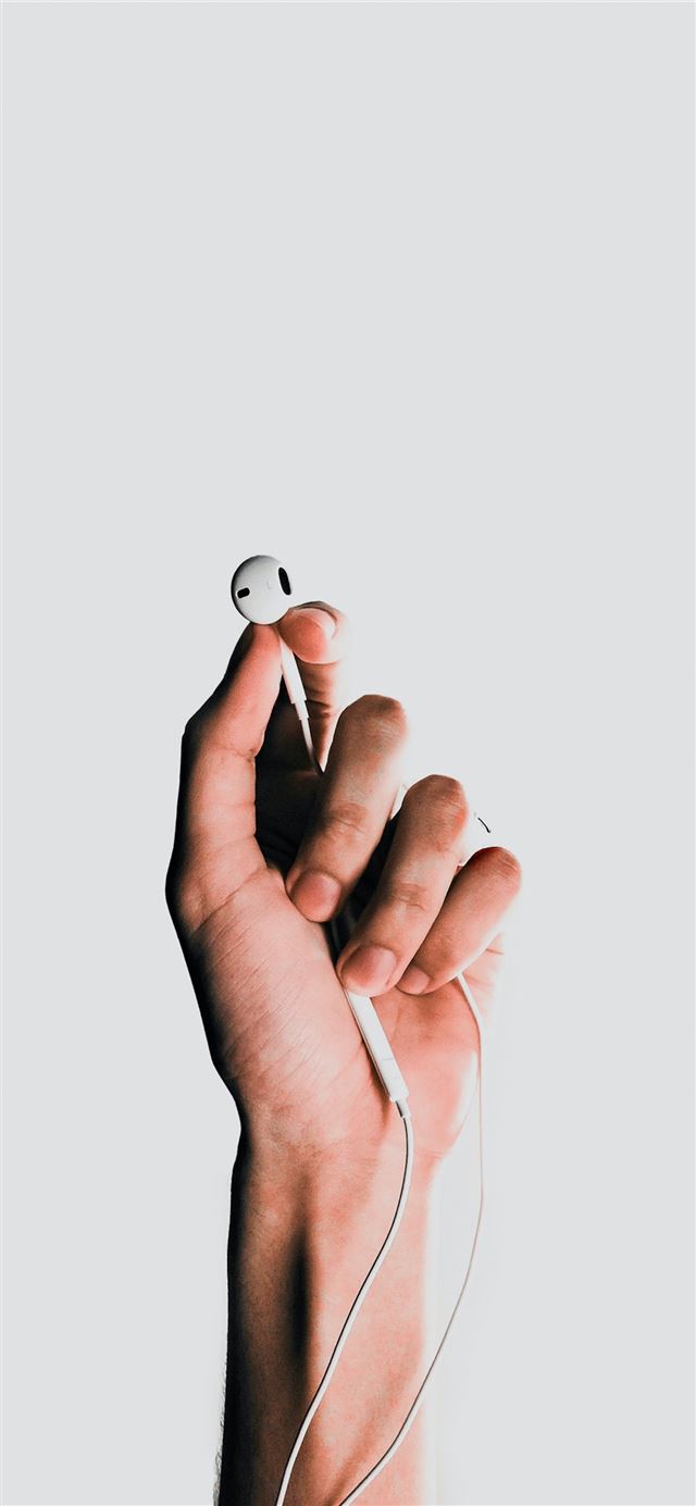 1125x2436 person holding Apple EarPods -  iPhone 11 Wallpaper