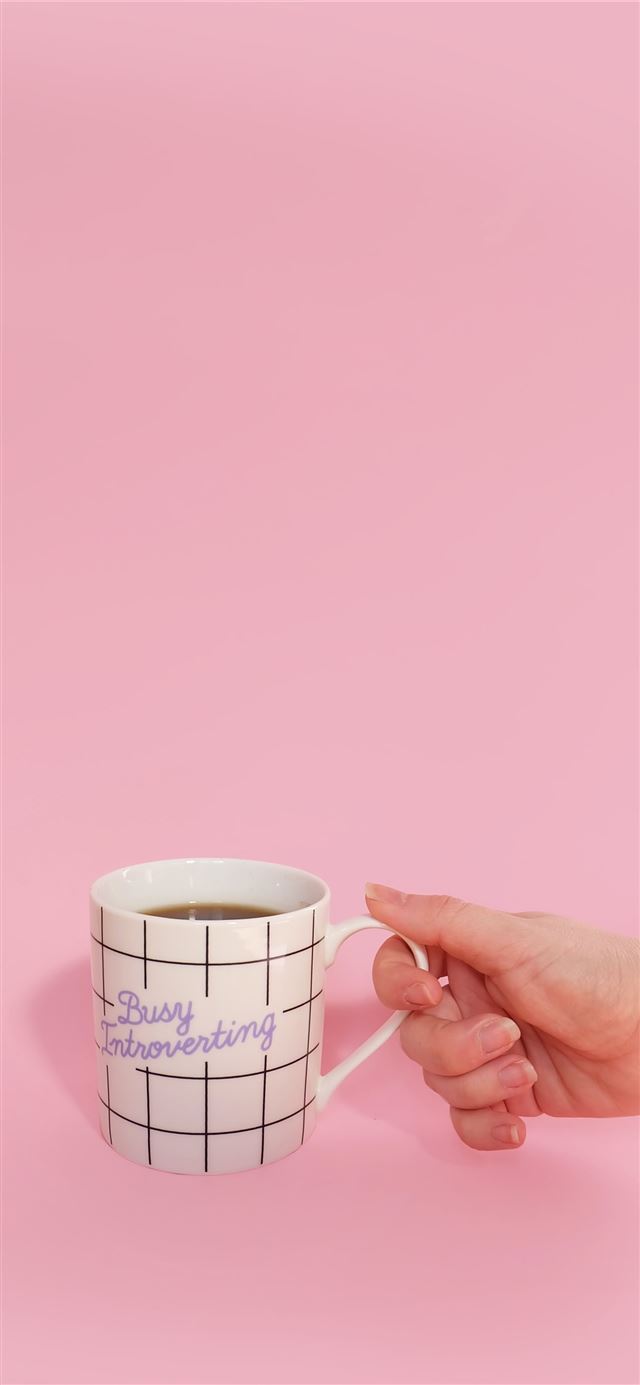 1125x2436 White Mug with a hand -  iPhone 11 Wallpaper