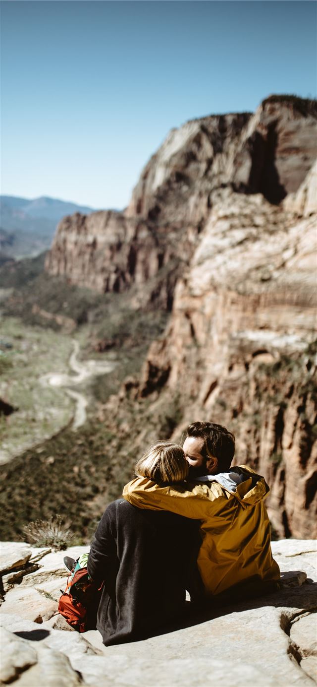 1125x2436 selective focus photography of couple sitting on r... -  iPhone 11 Wallpaper