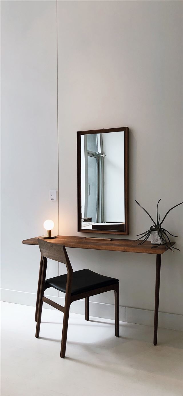 1284x2778 black leather chair with brown wooden frame in fro... -  iPhone 11 Wallpaper