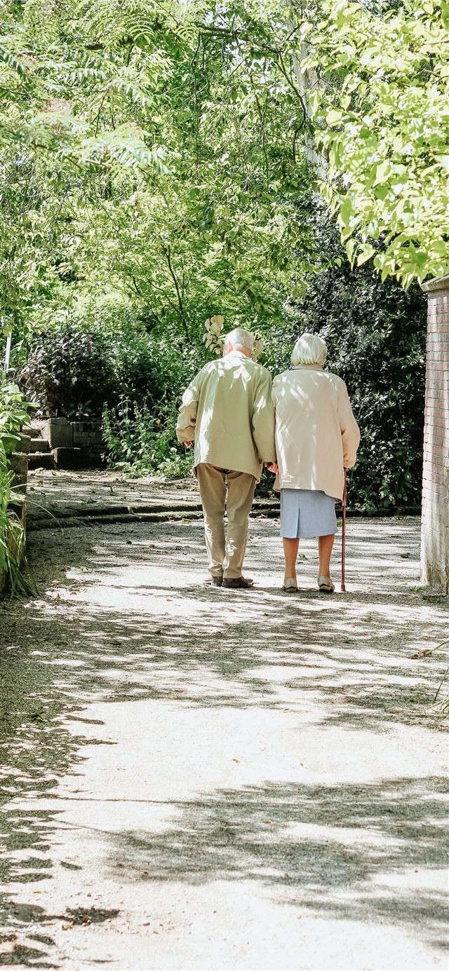 1125x2436 man and woman walking on road during daytime -  iPhone 11 Wallpaper