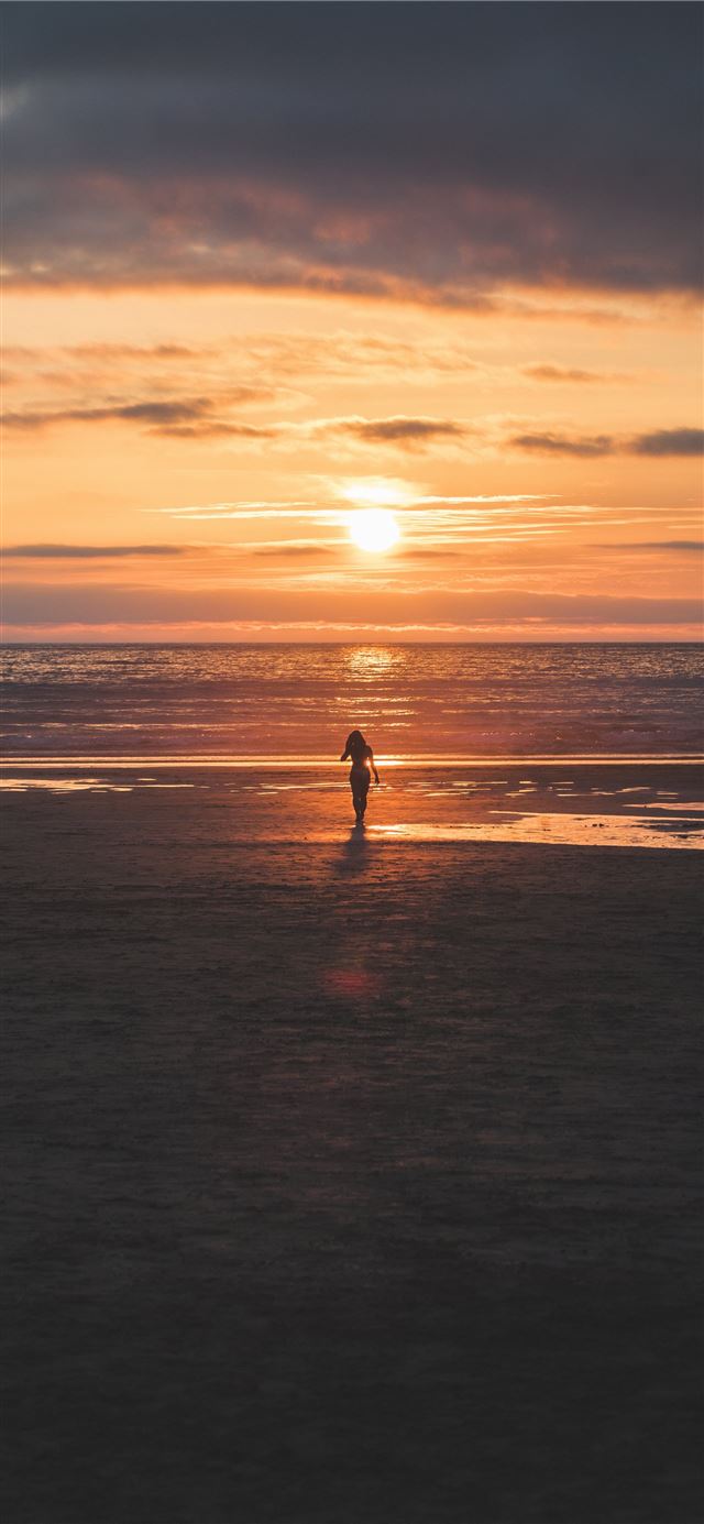 1284x2778 silhouette of woman standing on seashore -  iPhone 11 Wallpaper