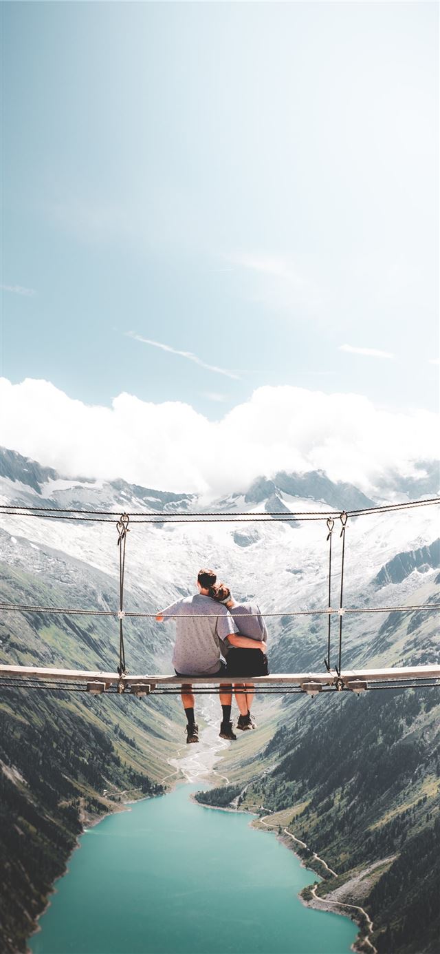 1284x2778 man and woman sitting on hanging bridge at daytime -  iPhone 11 Wallpaper
