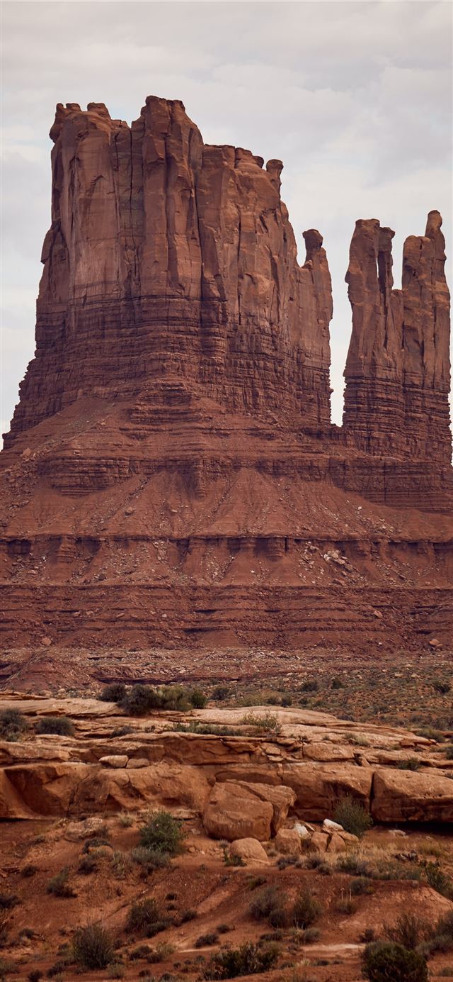 1125x2436 brown rock formations under white sky at daytime - utah iPhone 11 Wallpaper