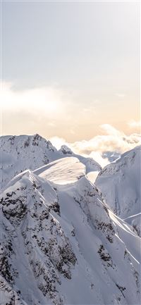 mountains covered by snow at daytime iPhone 11 wallpaper