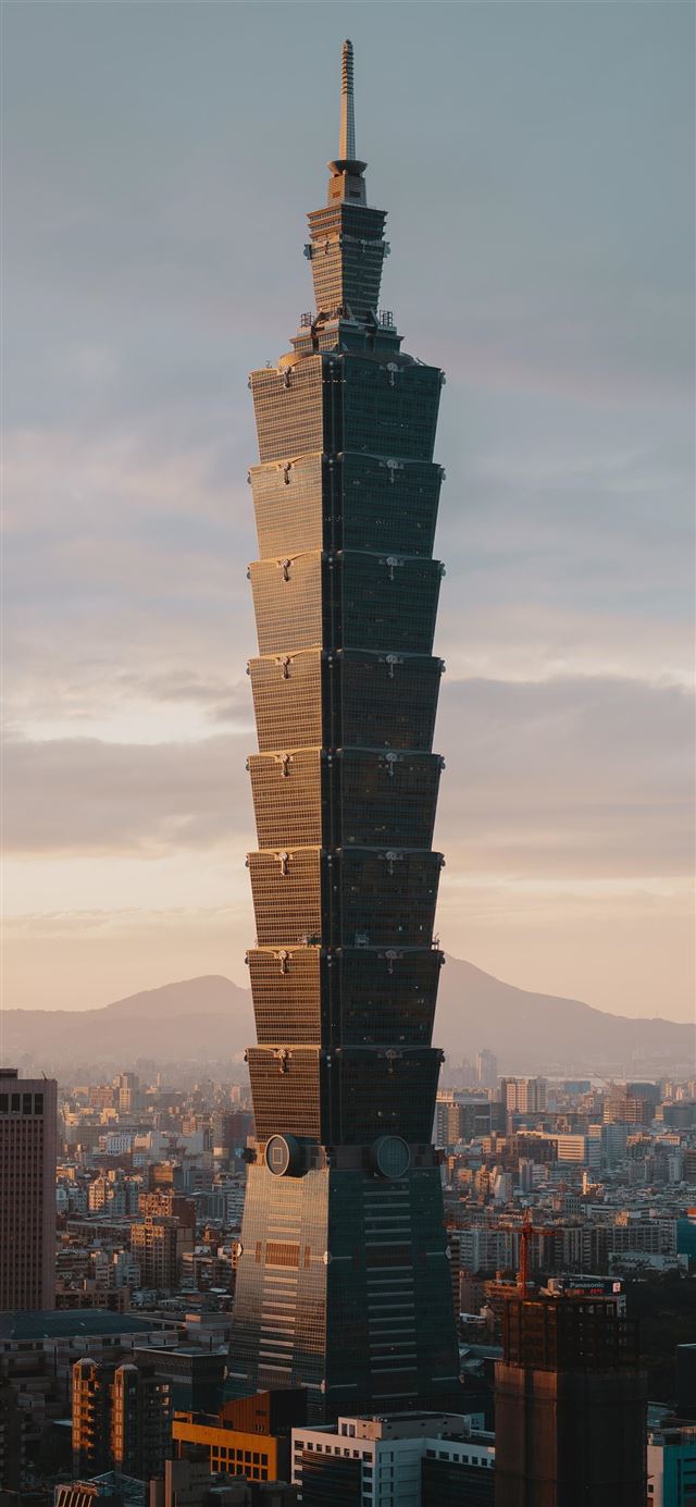 1125x2436 brown high rise concrete building under gray sky - city iPhone 11 Wallpaper