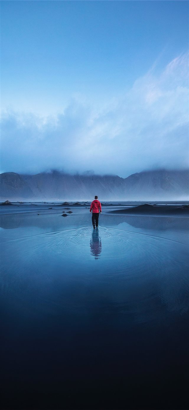 1125x2436 men standing on the ocean during faytime - sunset iPhone 11 Wallpaper