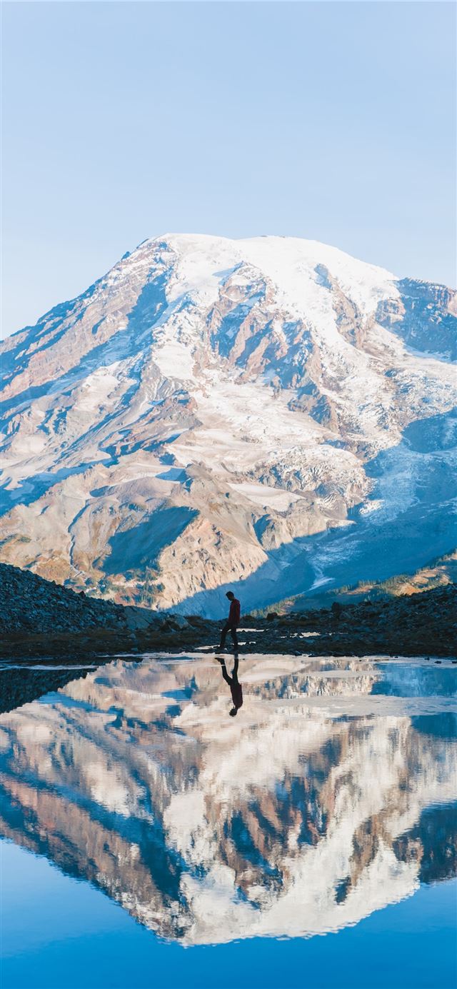 1125x2436 man walking near glacier mountain during day -  iPhone 11 Wallpaper