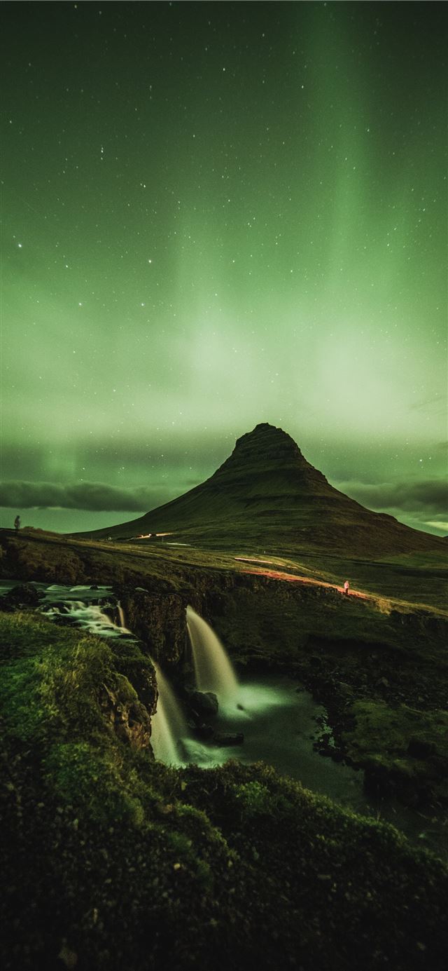 1125x2436 waterfalls near mountain taken under green sky - stars iPhone 11 Wallpaper
