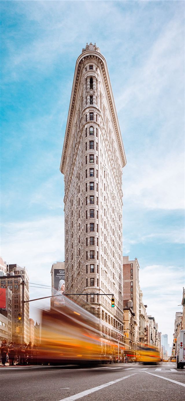 1125x2436 beige concrete building near cars - united states iPhone 11 Wallpaper