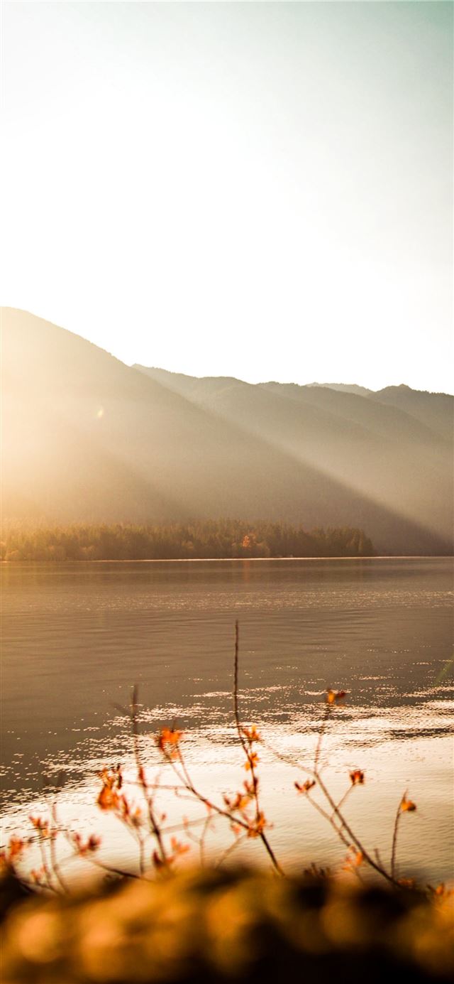 1125x2436 body of water near mountain - sunset iPhone 11 Wallpaper
